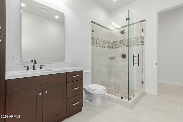 bathroom with toilet, tile patterned floors, walk in shower, and vanity