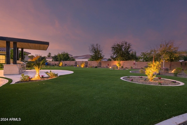 view of yard at dusk