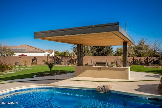 view of pool with a yard and a patio area