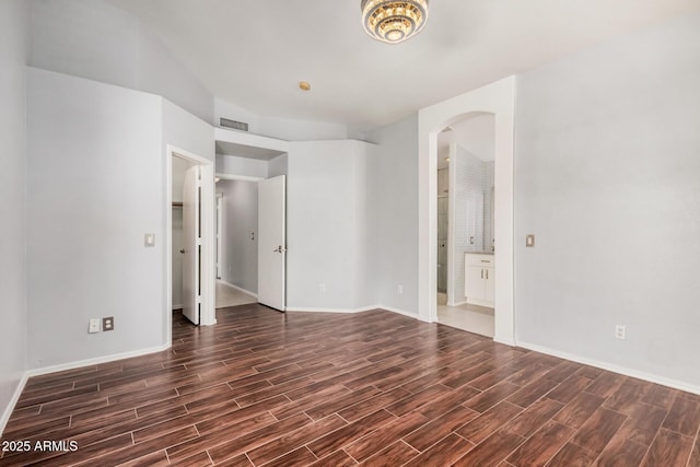 1712 E Saratoga St, Gilbert, AZ 85296 - spare room with visible vents, baseboards, arched walkways, and dark wood finished floors