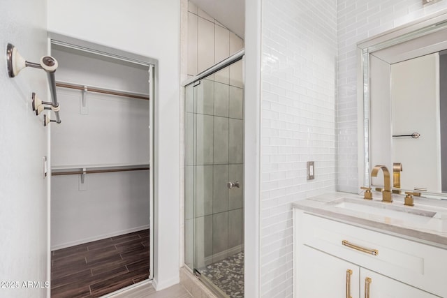 1712 E Saratoga St, Gilbert, AZ 85296 - full bath featuring wood finished floors, vanity, a spacious closet, and a stall shower