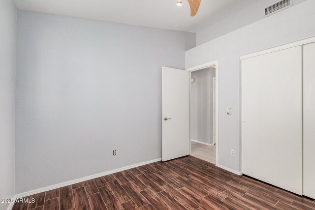 1712 E Saratoga St, Gilbert, AZ 85296 - unfurnished bedroom with baseboards, wood finish floors, visible vents, and a closet