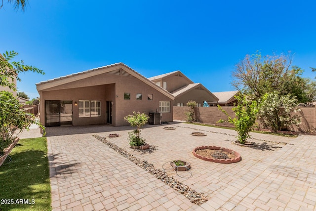 1712 E Saratoga St, Gilbert, AZ 85296 - exterior space featuring a fenced backyard, a tiled roof, cooling unit, stucco siding, and a patio