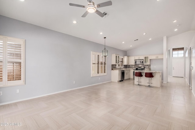 1712 E Saratoga St, Gilbert, AZ 85296 - living room with ceiling fan, baseboards, vaulted ceiling, and visible vents