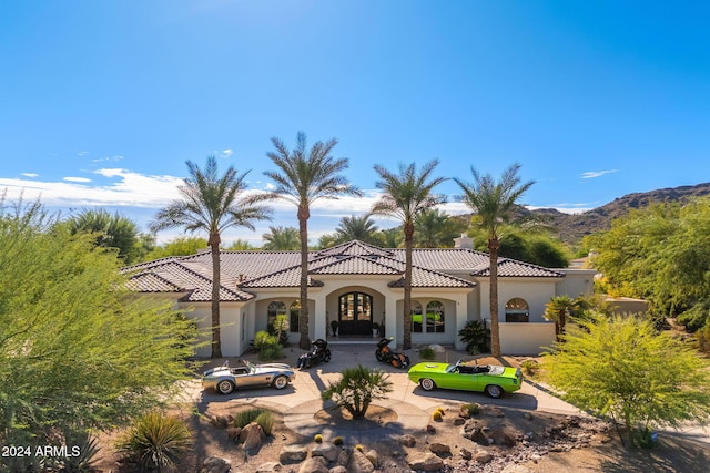 mediterranean / spanish-style home with a mountain view