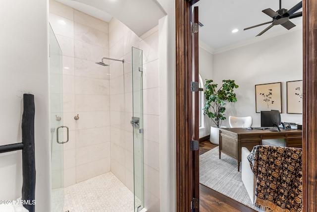 bathroom with wood-type flooring, a shower with door, ornamental molding, and ceiling fan