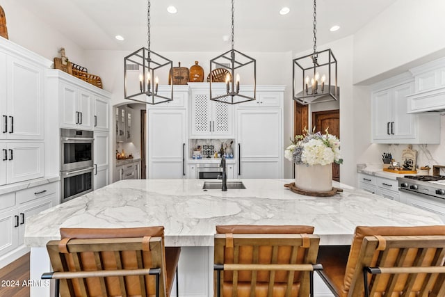 kitchen featuring a breakfast bar area, a large island with sink, and stainless steel appliances