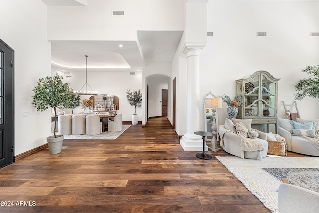 entrance foyer featuring dark hardwood / wood-style flooring, a high ceiling, and a chandelier