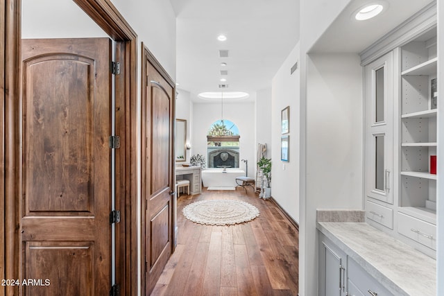 hall with hardwood / wood-style flooring