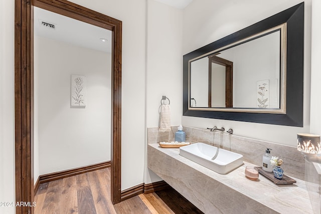 bathroom featuring sink and hardwood / wood-style flooring