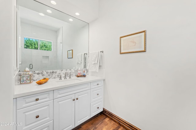 bathroom featuring vanity, a shower with shower door, and wood-type flooring