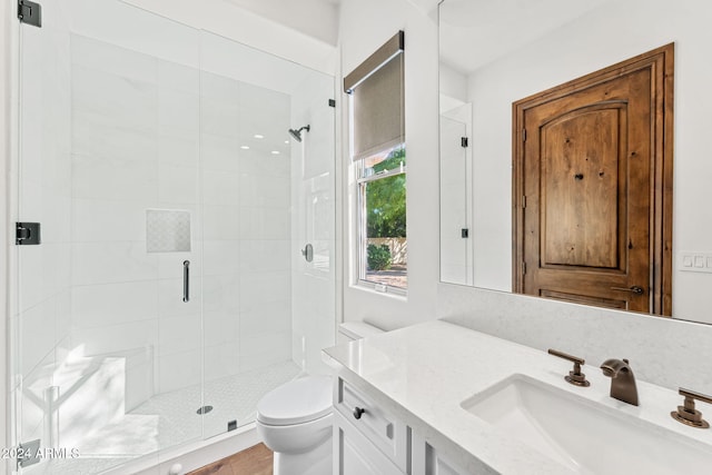 bathroom featuring an enclosed shower, vanity, toilet, and wood-type flooring