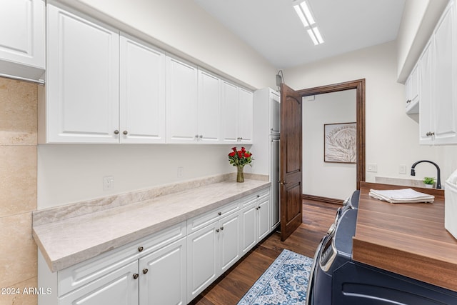 kitchen featuring dark hardwood / wood-style flooring and white cabinetry