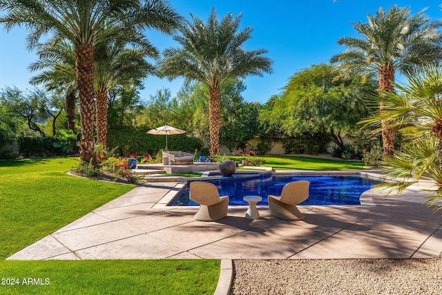 view of pool featuring a patio area and a lawn