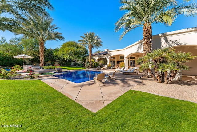 view of pool featuring a yard and a patio