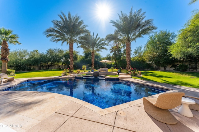 view of swimming pool featuring a yard and a patio area