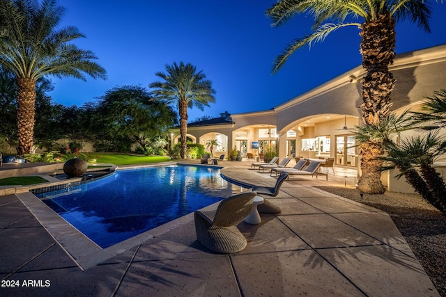 view of pool with french doors and a patio area