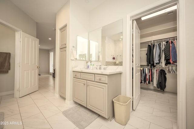 35317 N 31st Dr, Phoenix, AZ 85086 - bathroom with visible vents, baseboards, marble finish floor, vanity, and a walk in closet