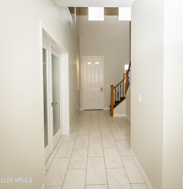 35317 N 31st Dr, Phoenix, AZ 85086 - corridor featuring marble finish floor, baseboards, a high ceiling, and stairway