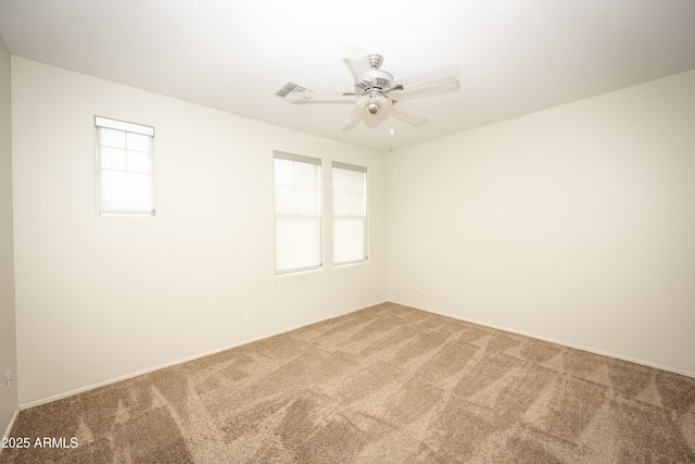 35317 N 31st Dr, Phoenix, AZ 85086 - empty room featuring carpet flooring, a wealth of natural light, visible vents, and a ceiling fan