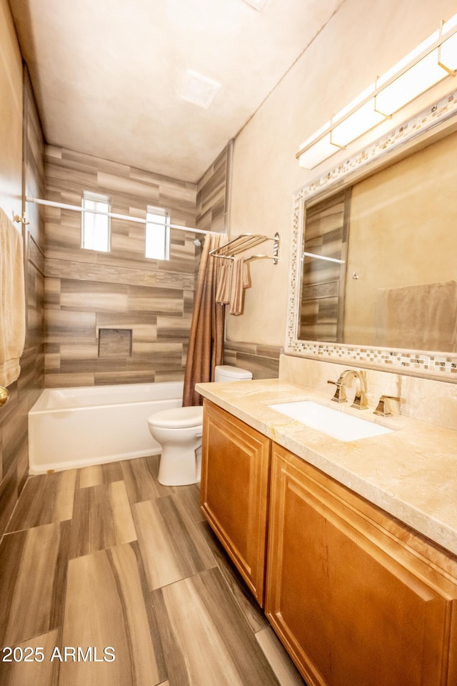 35317 N 31st Dr, Phoenix, AZ 85086 - full bathroom with vanity, tile walls, toilet, a wainscoted wall, and  shower combination