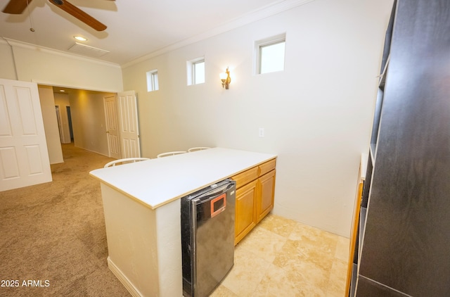 35317 N 31st Dr, Phoenix, AZ 85086 - kitchen with crown molding, light countertops, a ceiling fan, a peninsula, and light colored carpet
