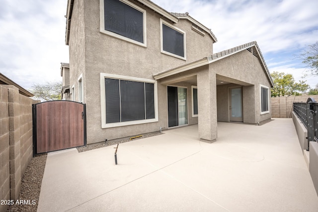 35317 N 31st Dr, Phoenix, AZ 85086 - rear view of property featuring stucco siding, a gate, a fenced backyard, and a patio