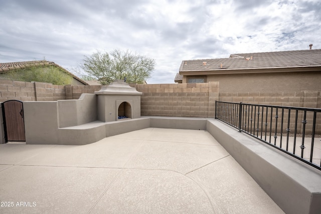 35317 N 31st Dr, Phoenix, AZ 85086 - view of patio / terrace featuring exterior fireplace and fence