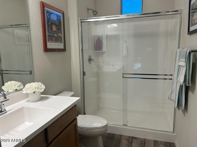 2525 N Riverside Dr, Florence, AZ 85132 - bathroom with a shower stall, toilet, vanity, and wood finished floors