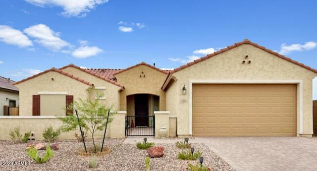 2525 N Riverside Dr, Florence, AZ 85132 - mediterranean / spanish-style house with stucco siding, a garage, a fenced front yard, driveway, and a tile roof