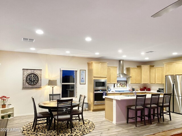 2525 N Riverside Dr, Florence, AZ 85132 - kitchen with appliances with stainless steel finishes, wall chimney exhaust hood, light brown cabinetry, light countertops, and recessed lighting