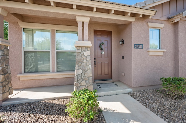 property entrance featuring stucco siding
