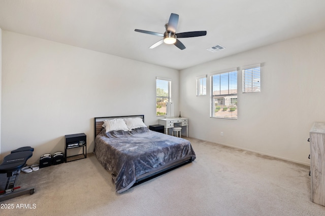 bedroom featuring a ceiling fan, visible vents, and carpet floors