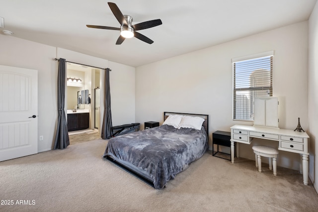 bedroom featuring ceiling fan, connected bathroom, and light colored carpet