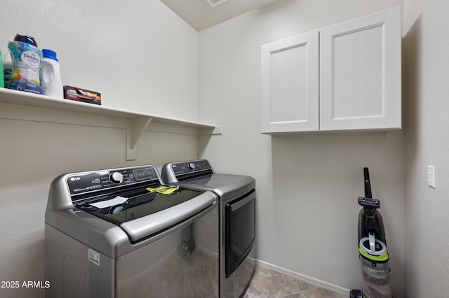 laundry room with independent washer and dryer, baseboards, and cabinet space