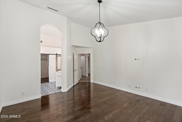 26264 N 46th St, Phoenix, AZ 85050 - unfurnished dining area with dark wood finished floors, a chandelier, baseboards, and arched walkways