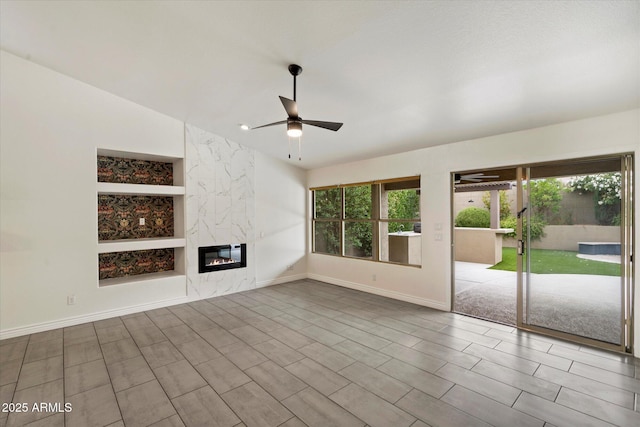 26264 N 46th St, Phoenix, AZ 85050 - unfurnished living room with ceiling fan, baseboards, a premium fireplace, and built in features