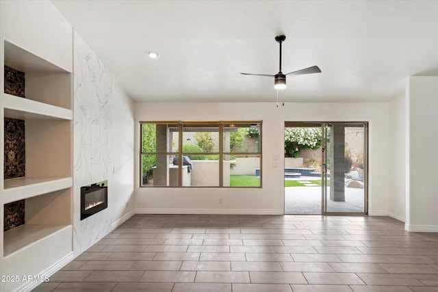 26264 N 46th St, Phoenix, AZ 85050 - unfurnished living room with a ceiling fan, a fireplace, and baseboards