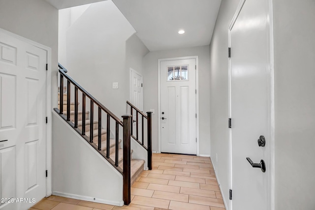 entryway featuring recessed lighting, baseboards, and stairs