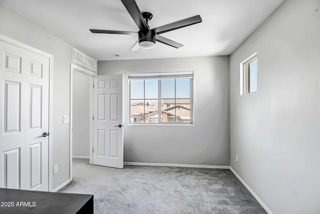 unfurnished bedroom featuring ceiling fan, carpet floors, and baseboards