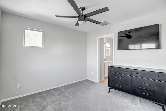 unfurnished bedroom featuring ceiling fan, connected bathroom, light carpet, visible vents, and baseboards