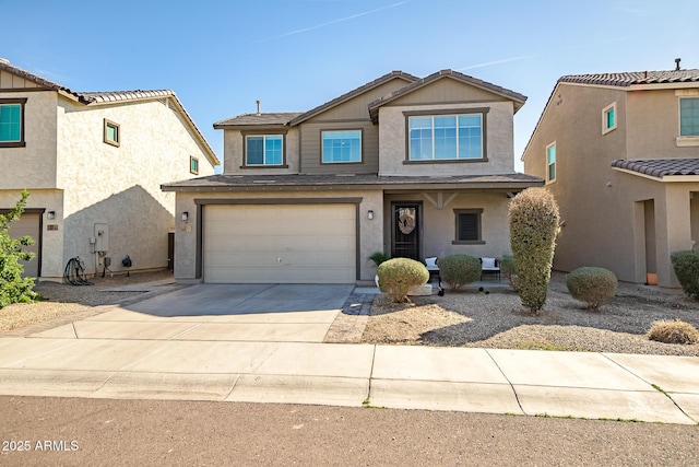 traditional-style home featuring an attached garage, concrete driveway, and stucco siding