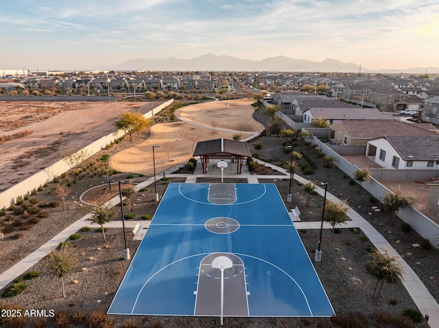 view of sport court featuring community basketball court, a residential view, and a mountain view