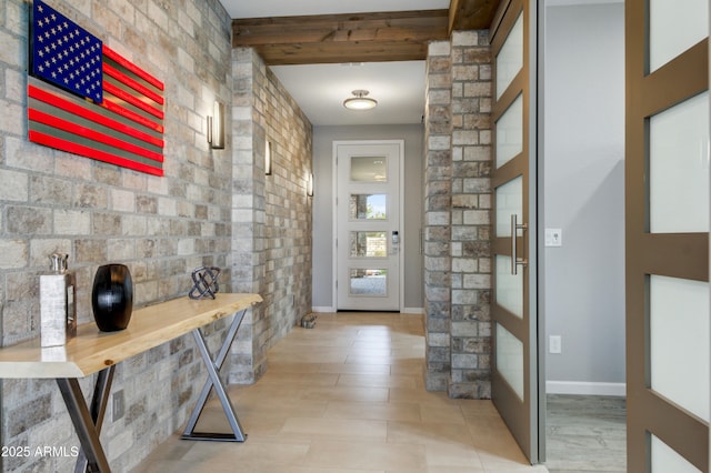 doorway to outside featuring beamed ceiling