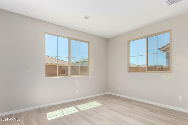 empty room with light wood-type flooring and a healthy amount of sunlight