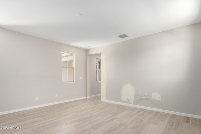 unfurnished room with light hardwood / wood-style floors