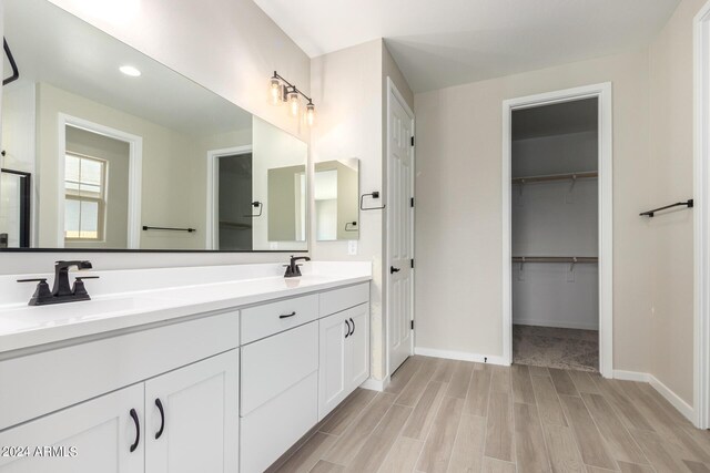 bathroom with hardwood / wood-style floors and vanity