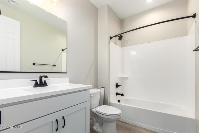 full bathroom with wood-type flooring, vanity, toilet, and shower / bath combination