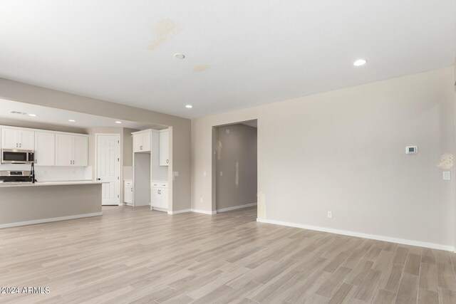 unfurnished living room with light hardwood / wood-style flooring