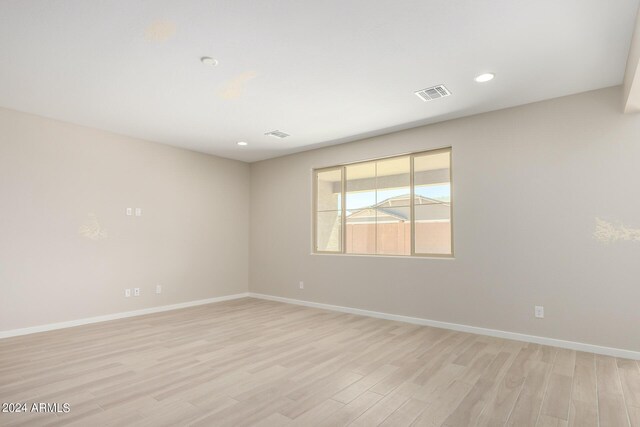 spare room featuring light hardwood / wood-style floors